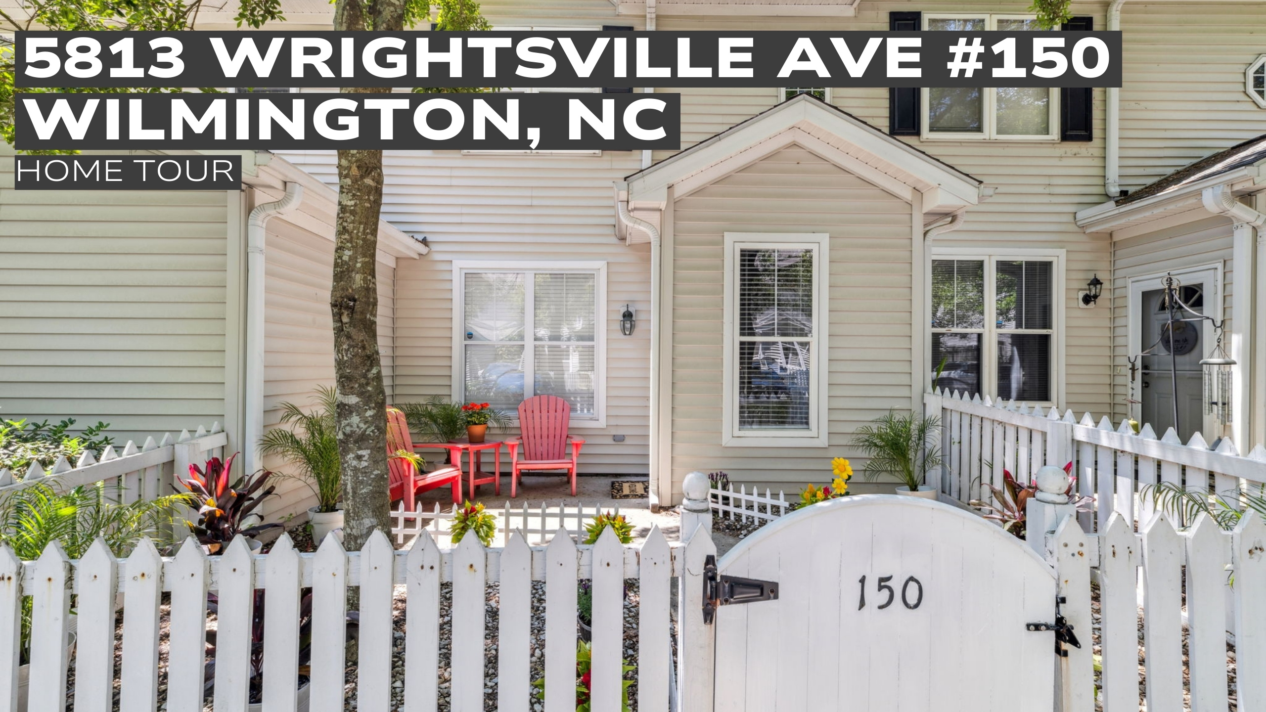 Exterior view of 5813 Wrightsville Ave #150 townhome with white picket fence and front patio in Wilmington, NC